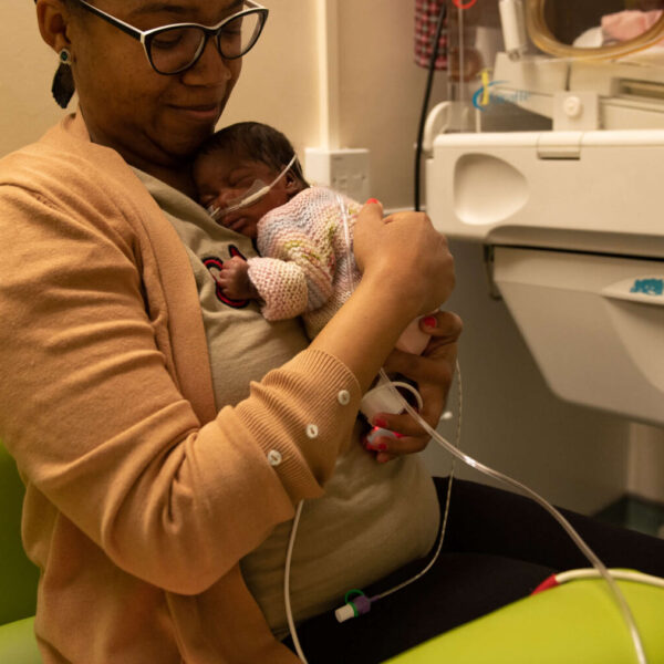 A mother holds her newborn infant on the neonatal unit.