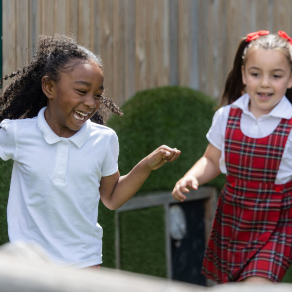 Two girls playing at a school playground