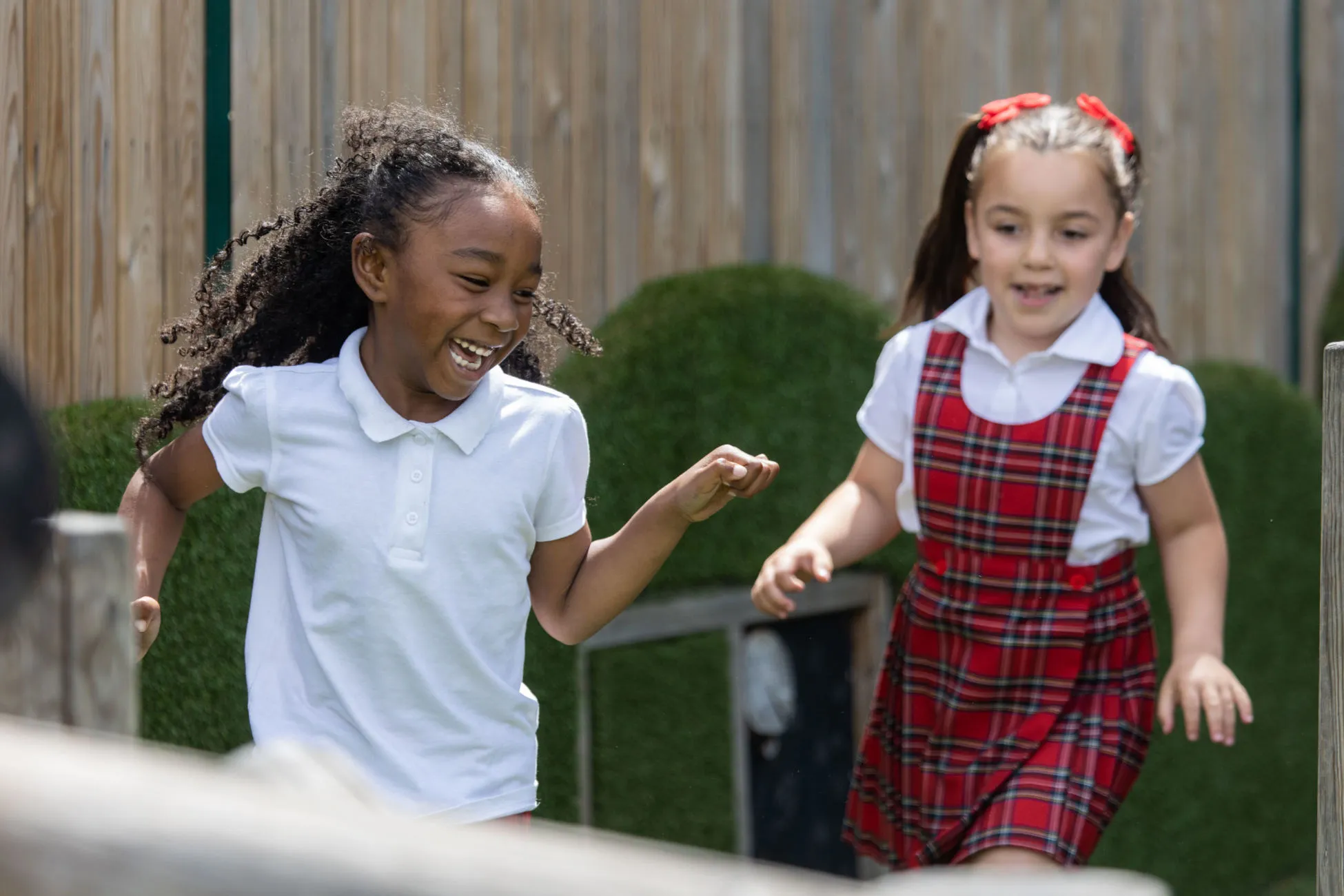 Two girls playing at a school playground