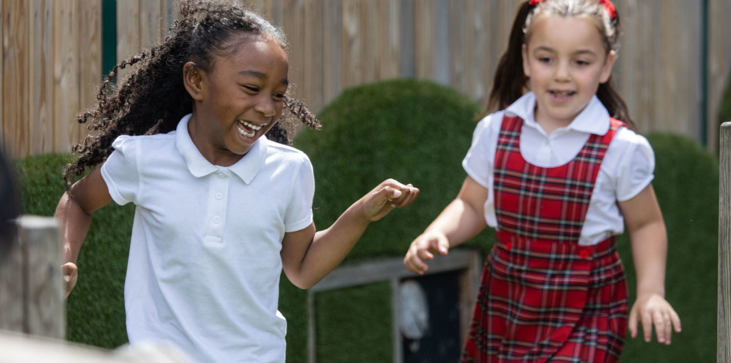 Two girls playing at school playground