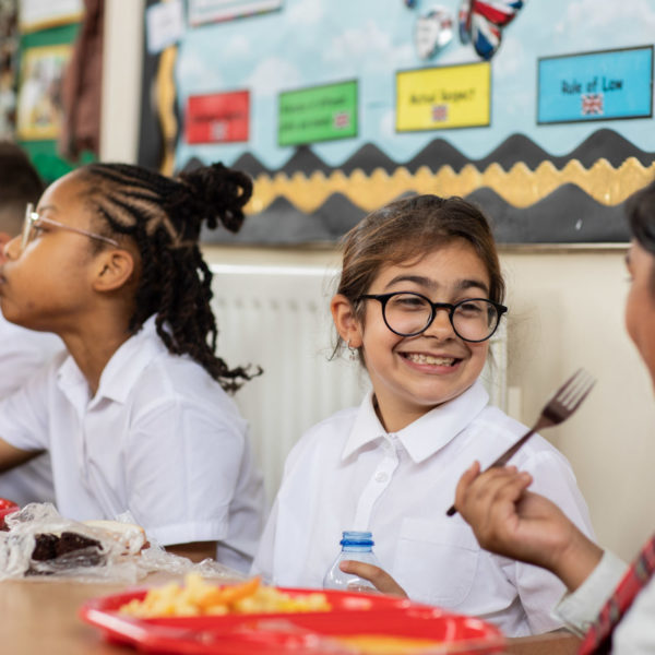 Pupils interacting and smiling whilst having lunch