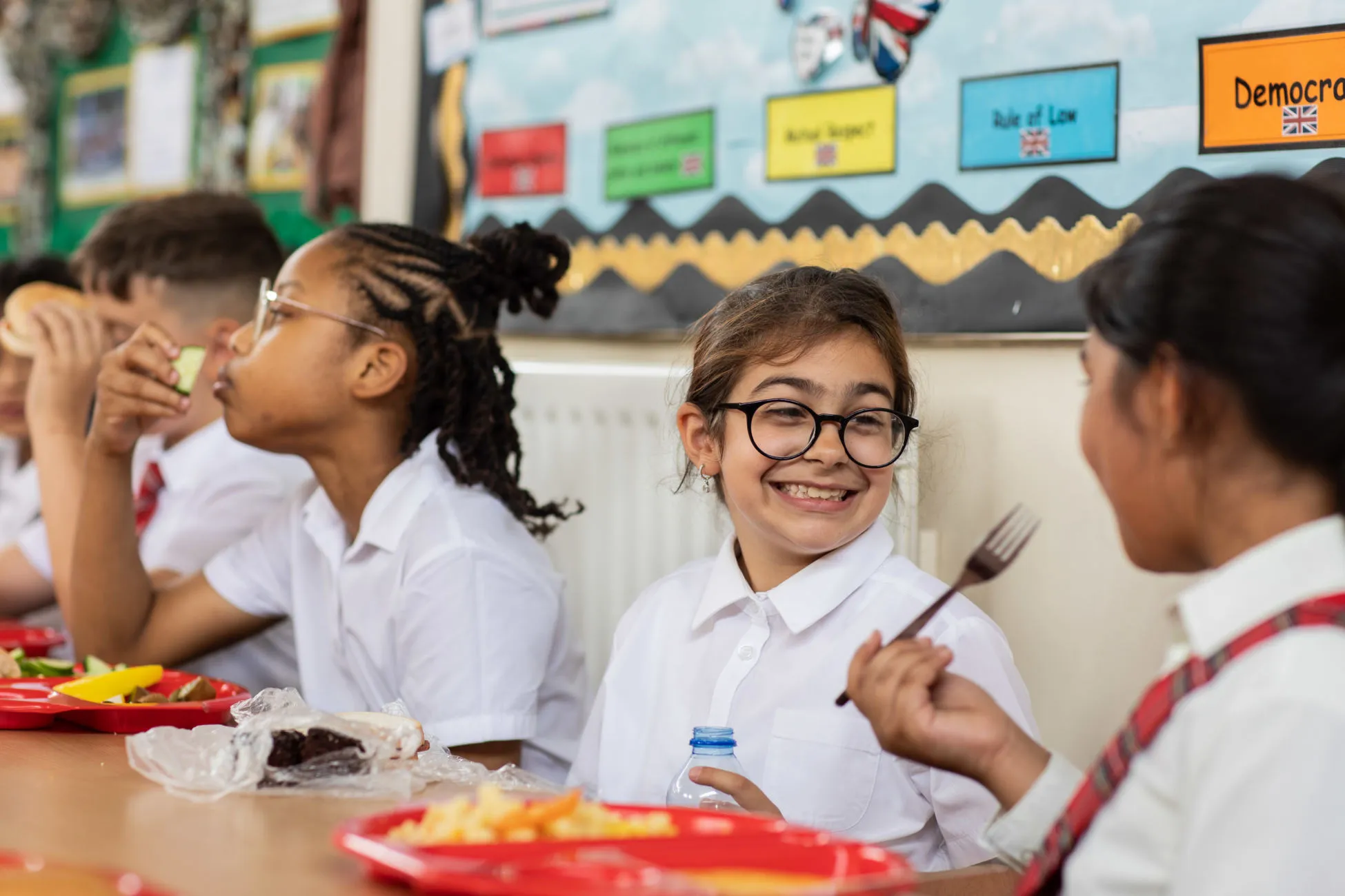 Pupils interacting and smiling whilst having lunch