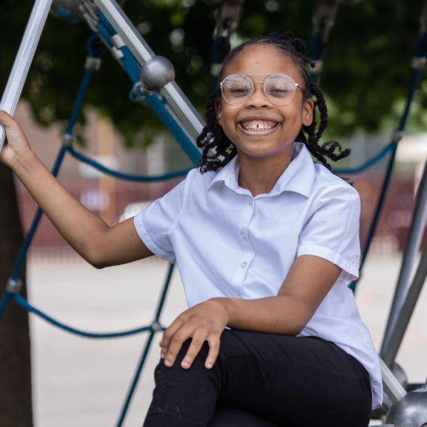 A girl smiling at a school playground