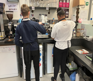 Children from Grange School working in the school's cafe where they learn valuable skills and interact with the wider community.