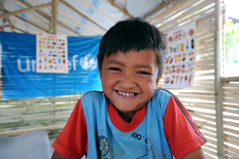 Sanjay Maharjan, 5, smiles in UNICEF-supported tempoary learning center in Shree Rudrayanee Secondary School in Khokana