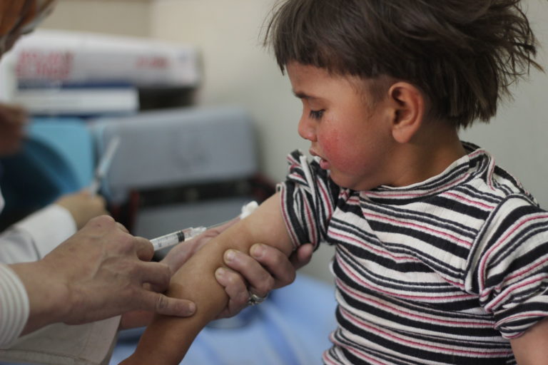 On 26 April 2016, Louai, 4, is vaccinated in Aleppo City as part of Syria's first ever nationwide routine immunization campaign since the start of the five year conflict. Until recently, the siblings lived in Al-Bab town in rural eastern Aleppo, one of the most dangerous areas to live due to the war. Their mother recently fled with her children to shelter with relatives in Aleppo city. Hearing about the campaign from neighbours, she took her four children to the nearest health centre, along with their cousin. The first full nationwide immunization campaign since the start of the five-year conflict in Syria, began on 24 April 2016, at the start of World Immunization Week. The campaign, supported by UNICEF and WHO, aims to reach all children under the age of five years old including those living under siege and in hard-to-reach areas, where routine vaccination is almost non-existent and many children have never received any vaccinations. Access to children in these areas is key to the success of the campaign. After five years of conflict, national immunization rates have dropped from 90 per cent to 57 per cent, putting the country's 2.8 million under-five-year-old at risk of life-threatening vaccine preventable diseases. In this campaign, children will be immunized against polio, measles, rubella, pertussis (whooping cough), diphtheria, tetanus, hepatitis B and haemophilus influenza type B. Access for health workers is critical to protect these children from deadly diseases. Vaccination is being provided through fixed health centres, outreach activities and mobile teams where required.