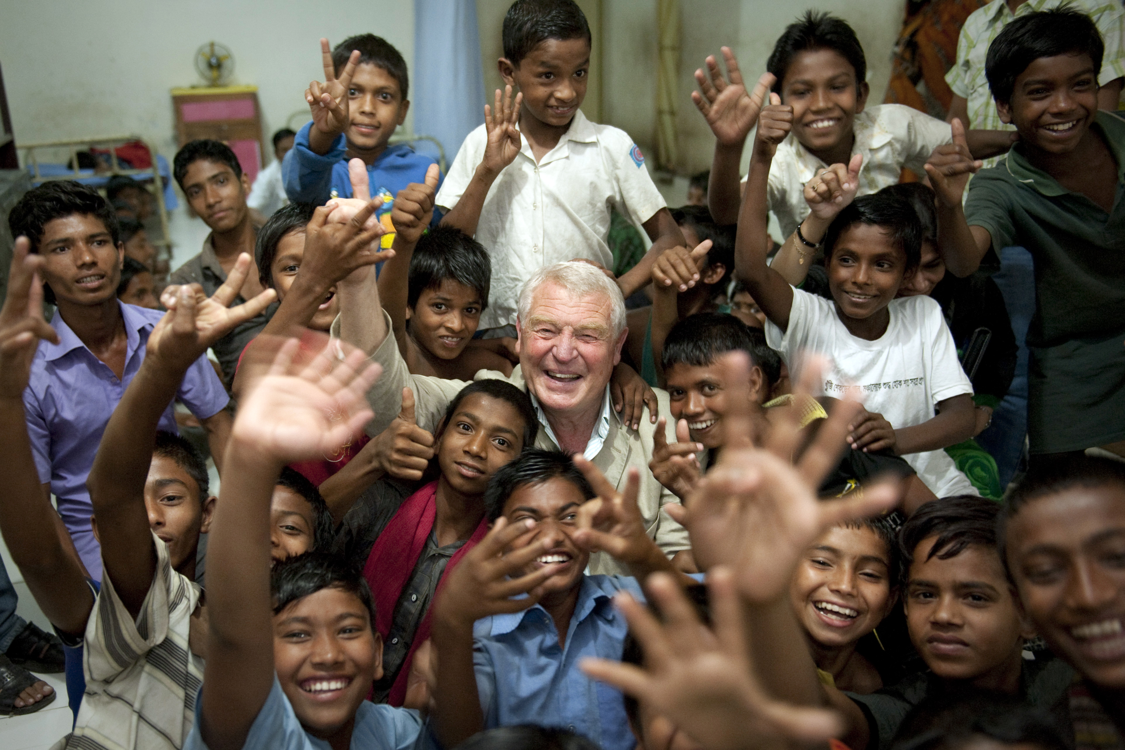 Paddy Ashdown smiling with a group of children.
