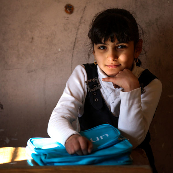 Janna, 8, from Baghdad, sits in a classroom with her new Unicef school bag after a school supply distribution for children from five schools in Baghdad's Al-Amiriyah District.