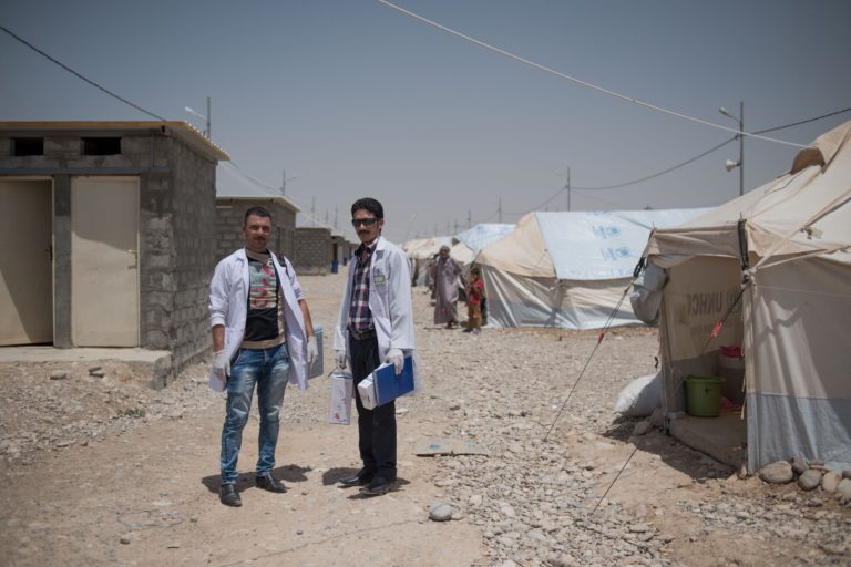 Samir and Thamir go door-to-door to ensure every child in the camp has the appropriate vaccinations. © UNICEF Iraq/2016/Mackenzie