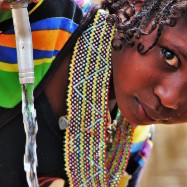 A girl collects water from a water point in a refugee camp in Cameroon.