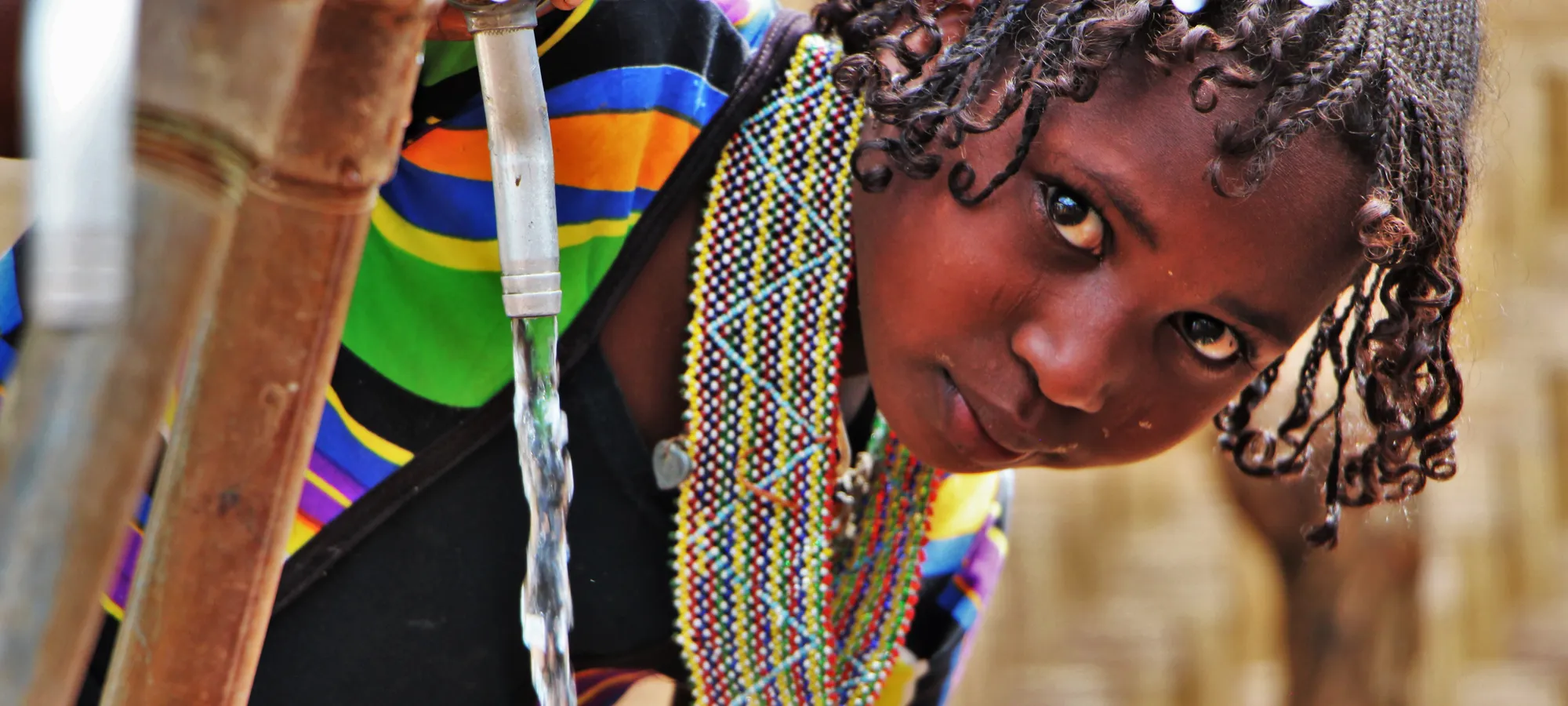A girl collects water from a water point in a refugee camp in Cameroon.