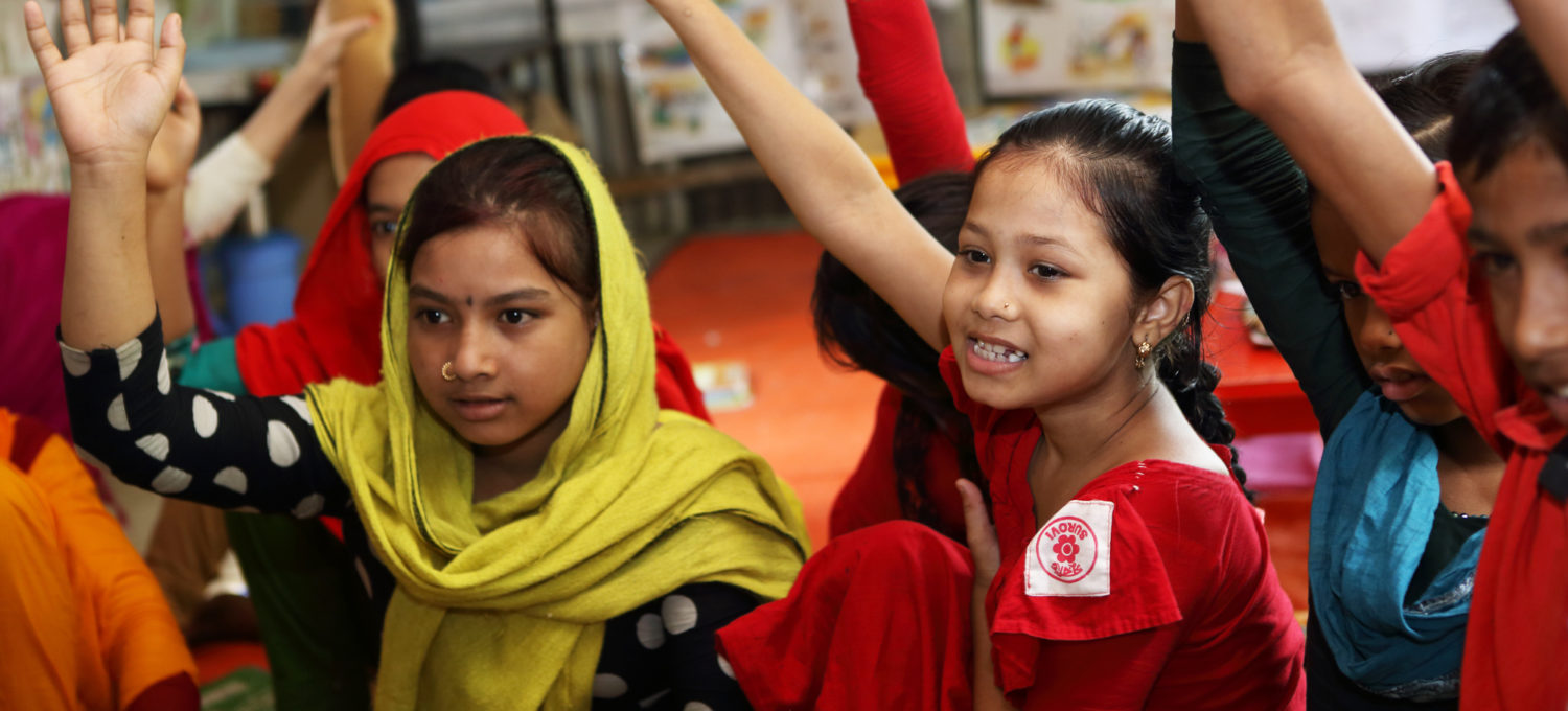 Children raise their hands at a Unicef-supported school in Bangladesh. Photo: Unicef 2016 Kiron