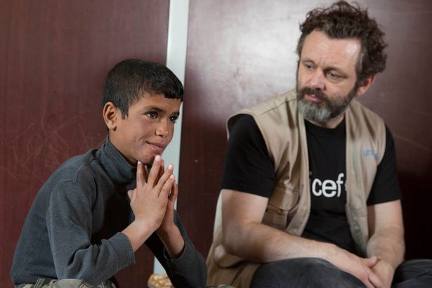 Unicef Uk Ambassador Michael Sheen listens to 12-year-old Majd, who works to support his family. Photo Unicef/2016/Vogler