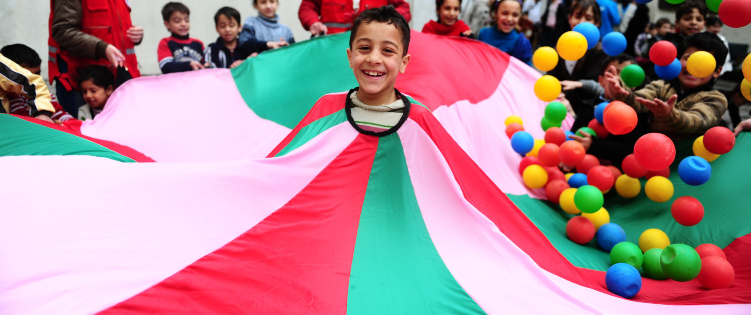 Children laugh during a Unicef-supported recreation activity at a shelter for displaced families in Homs, capital of Homs Governorate. The activity is part of psychosocial services to help children recover from trauma caused by the conflict. Unicef/2014