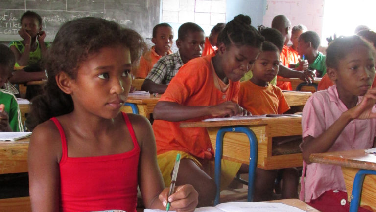 A girl listens to a teacher at a cycloneproof schools in Madagascar