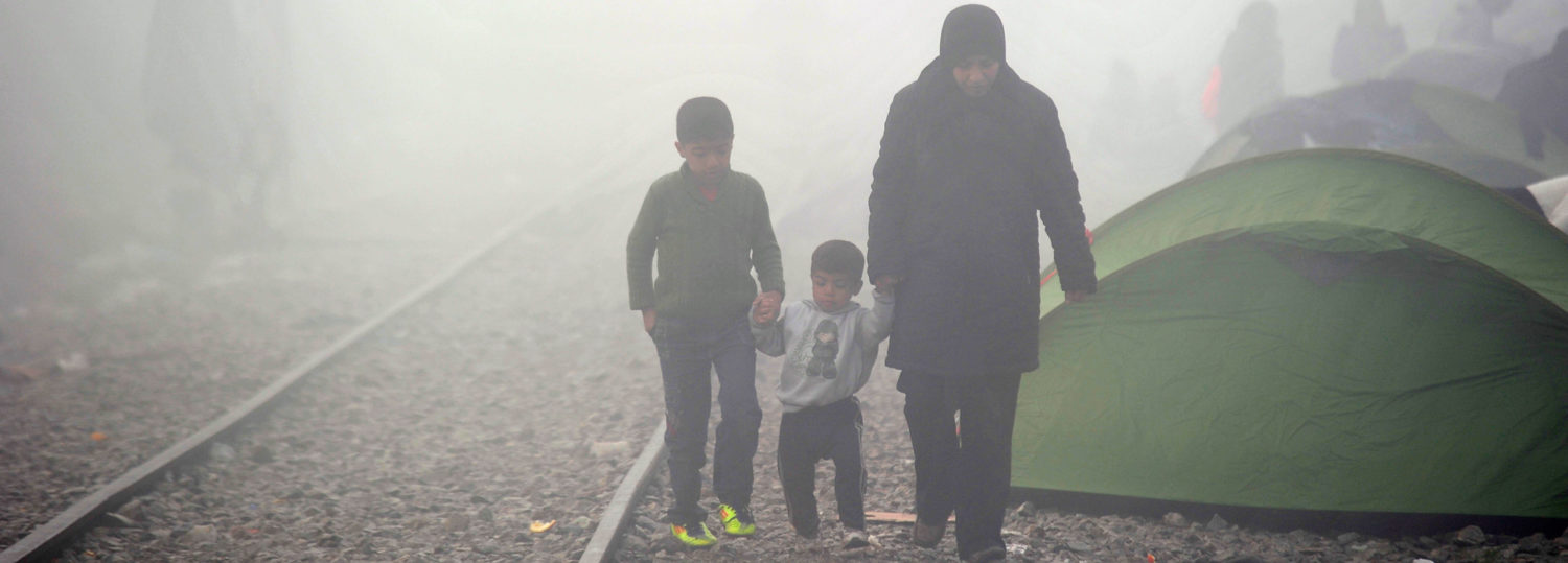 A mother and her two sons walk down a misty train track in Idomeni, Greece. Unicef/2016/Georgiev