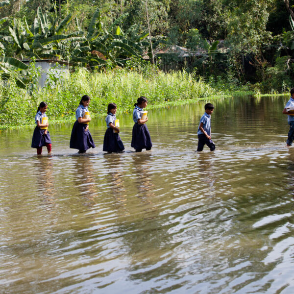 Climate Change: Students make their way to school after heavy floods in Bogra, Bangladesh. Photo: Unicef/2014/Paul
