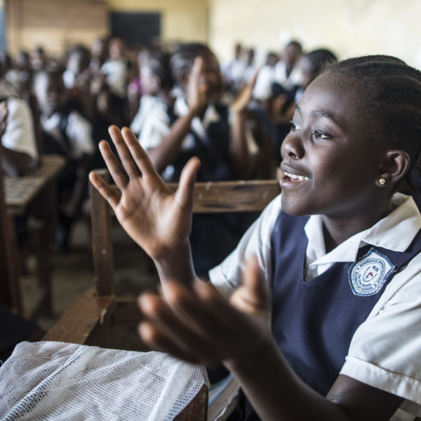 A girl claps during a sing-along in a class at Monrovia Demonstration School in Monrovia, the capital, on the first day of the new academic year.