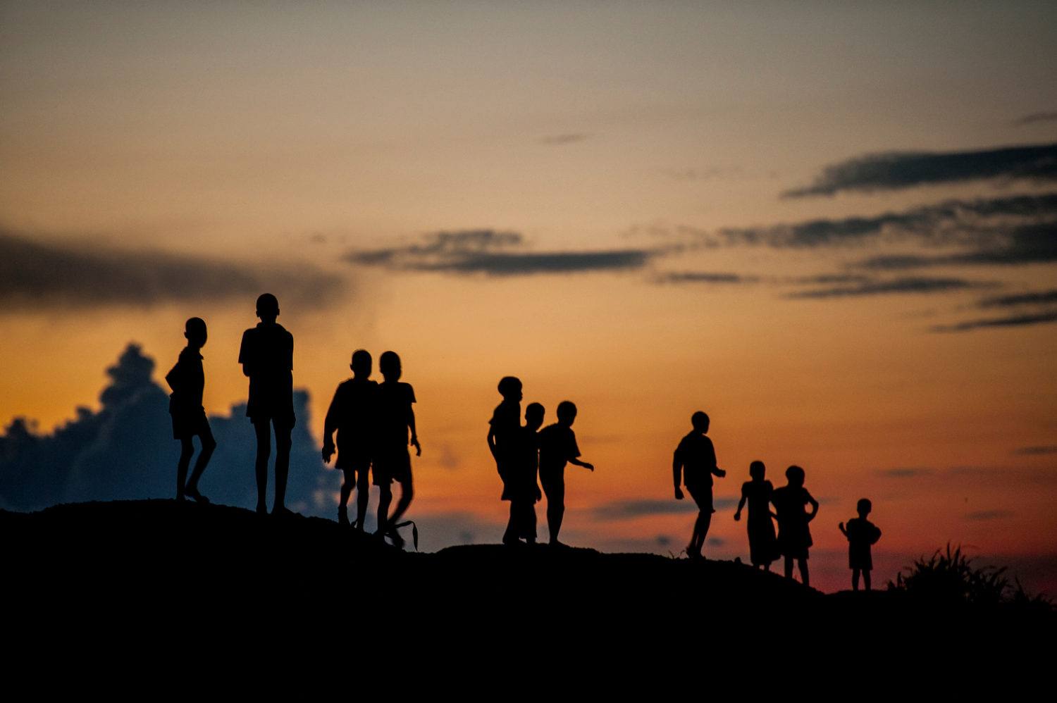 On 14 August 2016 in the Protection of Civilians (POC) site near Bentiu, in Unity State, South Sudan, children play at dusk.