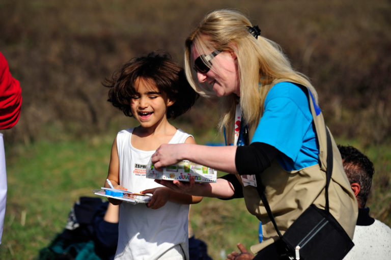 On 23 February 2016, refugee and migrant families pass through the Gevgelija transit center on the border with Greece. As border changes in the Balkan region create confusion and chaos, hundreds of refugees from Afghanistan and Iraq returned to Greece. UNICEF and partners are providing food and drawing books to children in this location. Child and Family Support Hubs, known as “Blue Dots,” provide a safe space for children and their families, vital services, play, protection and counselling in a single location. The Blue Dot hubs in this location were operational as of the end of January 2016. In February, women and children made up nearly 60 per cent of sea arrivals to Europe, compared to 27 per cent in September 2015. Unicef/2016/Georgiev