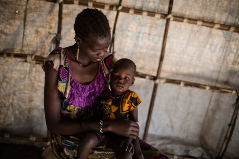 Jany Kuong, 20, holds her baby girl Nyakuiy Kay. 