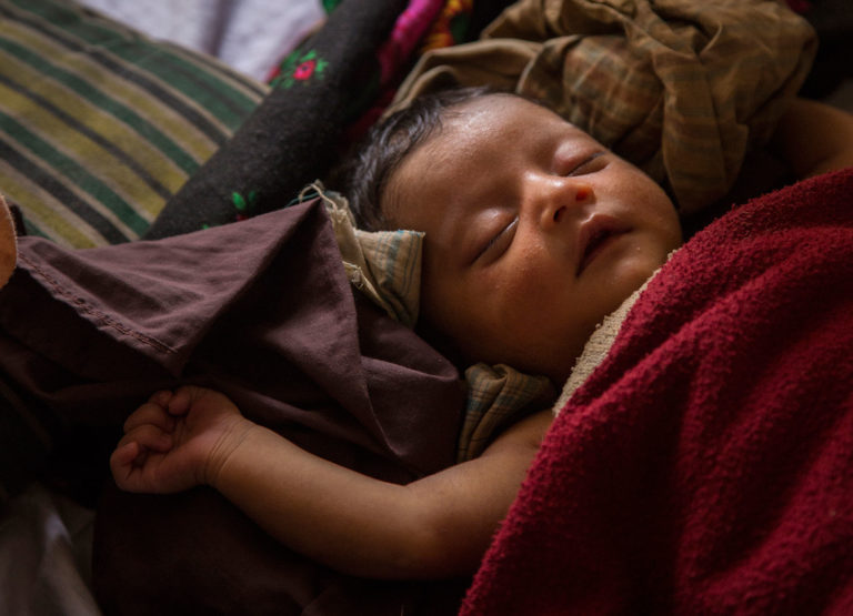 Newborn Rohingya refugee Kismat Ara, sleeps in the Unicef-supported birthing centre in the Kutupalong camp for Rohingya refugees in Cox's Bazar, Bangladesh. Unicef/2017/LeMoyne