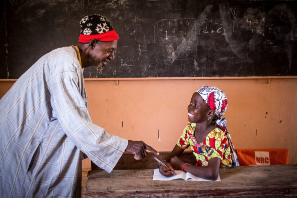Koumbéré Sankaré, 12, from Diambadougou village with the facilitator of her community learning center, Halala Tamboura.