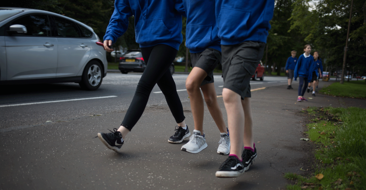 Children make their way to school alongside a busy road. Photo: Unicef/2018/Sutton-Hibbert