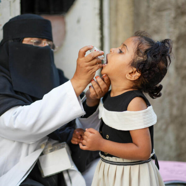 A young girl receives a polio vaccination near her home in Aden, Yemen, as part of a critical polio campaign to protect children from the disease.