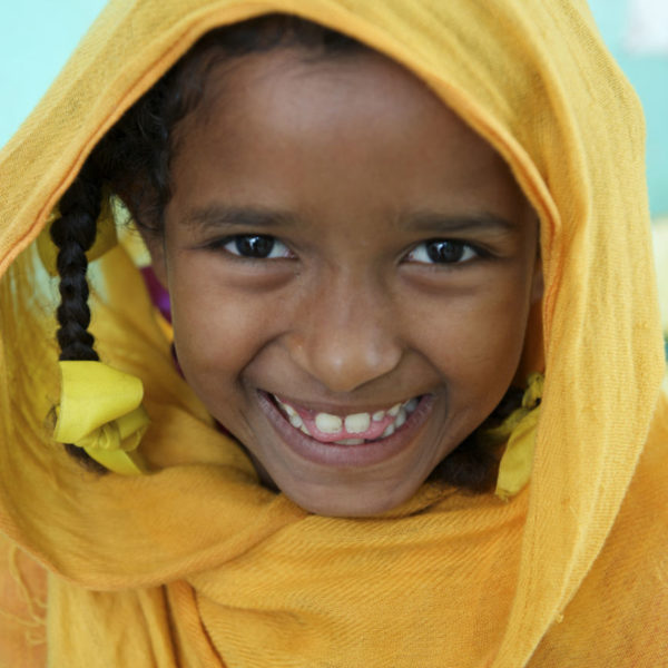 Portrait of a young girl at a nutrition Centre at Qarar Ibn-e-Al Khatab Nutrition Centre in Port Sudan. Sudan. smiles, happy.
