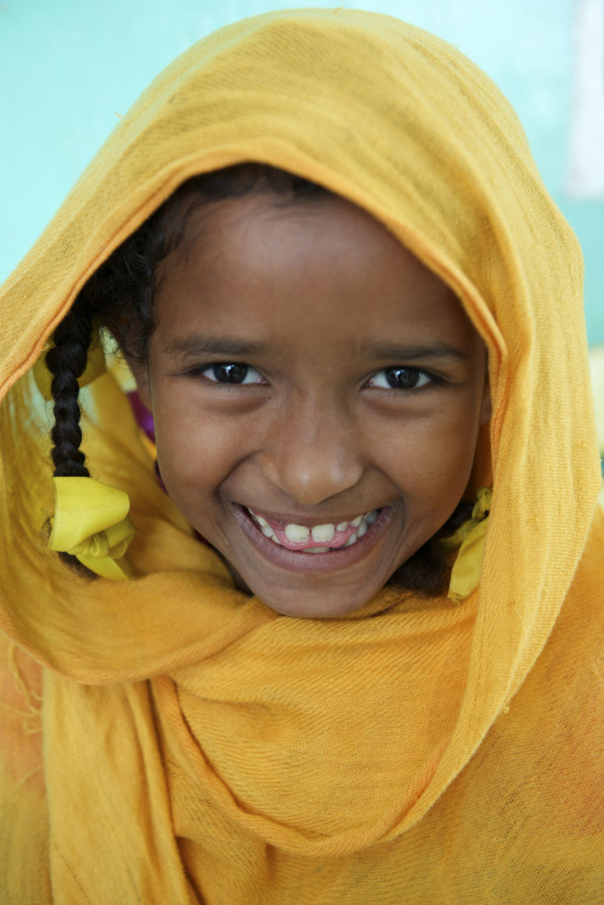 Portrait of a young girl at a nutrition Centre at Qarar Ibn-e-Al Khatab Nutrition Centre in Port Sudan. Sudan. smiles, happy.