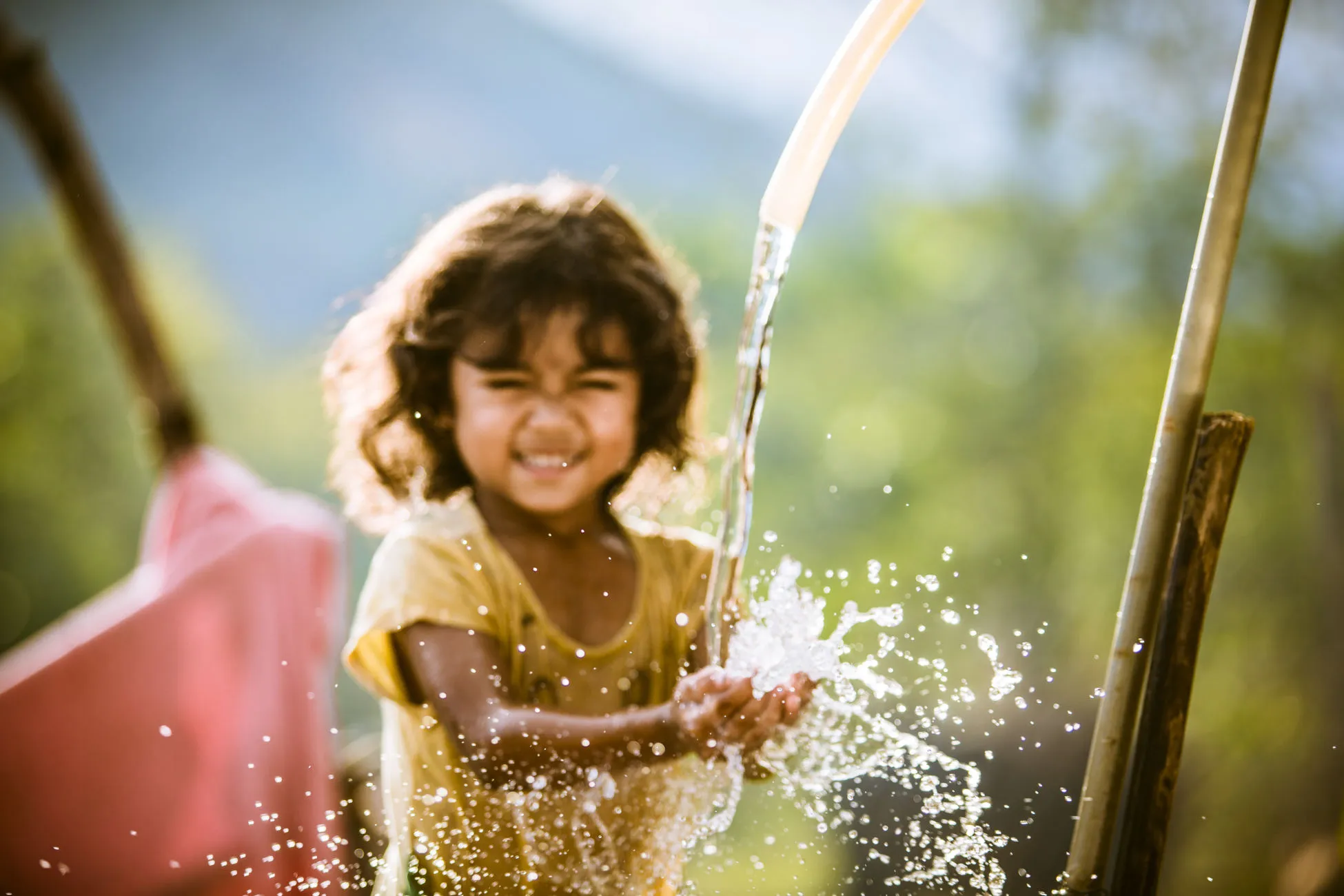 Girl enjoys her family's clean water source in Bac Ai, Phuoc Hoa, Ninh Thuan.