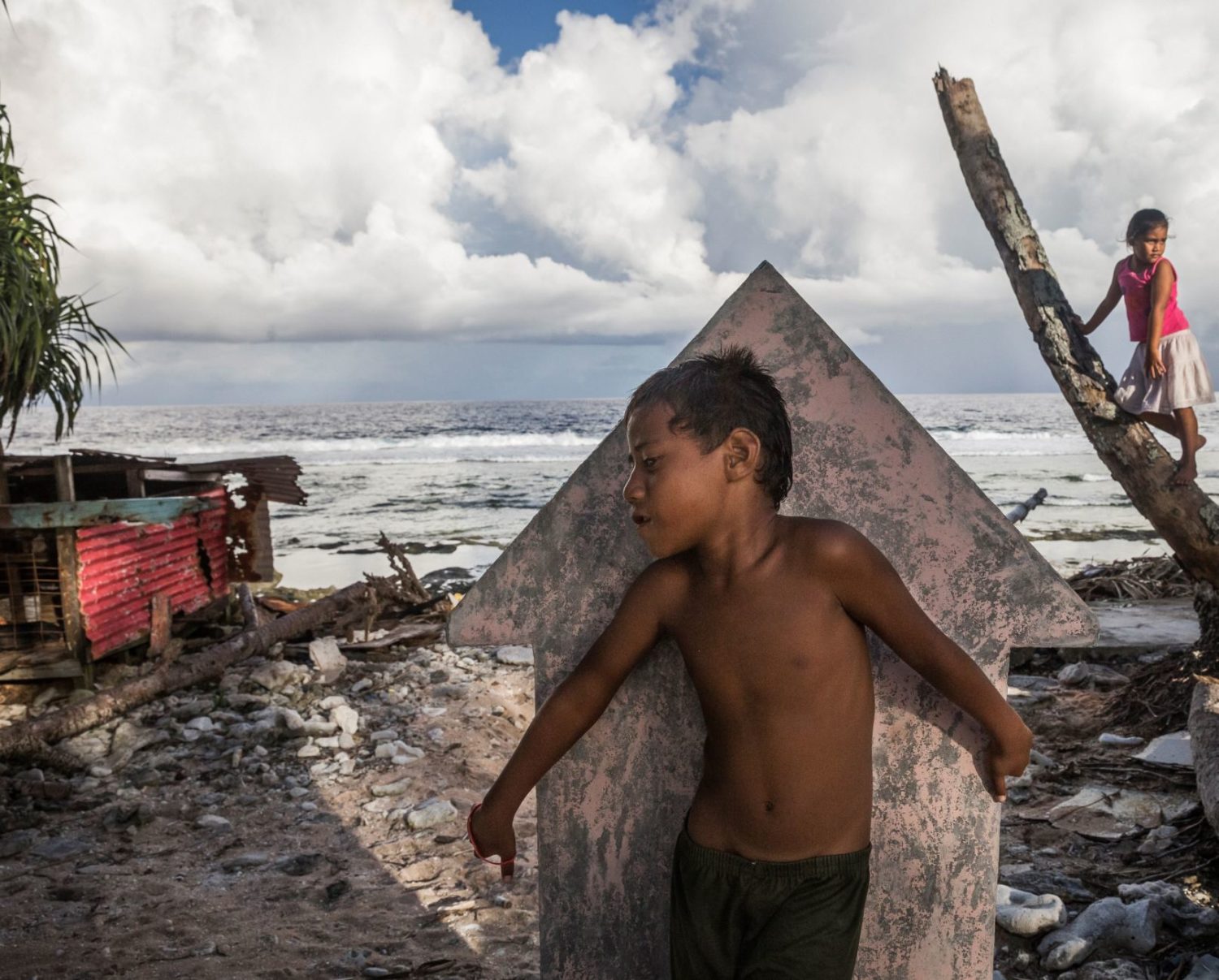 Children playing 'hide and seek' in Teone's graveyard in Tuvalu.