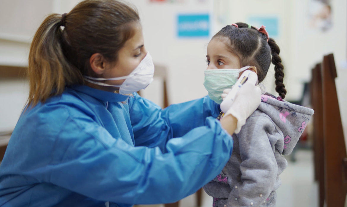 A Nurse checks a child's temperature