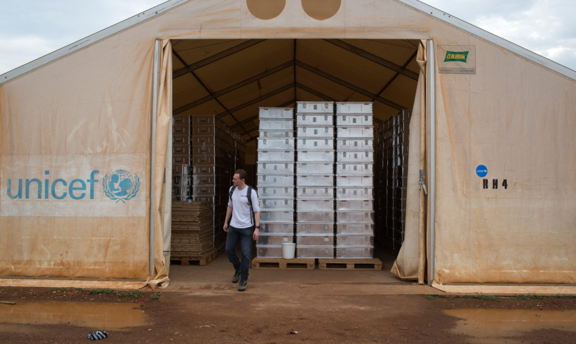 UNICEF UK Ambassador Tom Hiddleston walks out of a UNICEF warehouse that stores recreation kits and school in boxes in Juba, South Sudan on February 26, 2015.