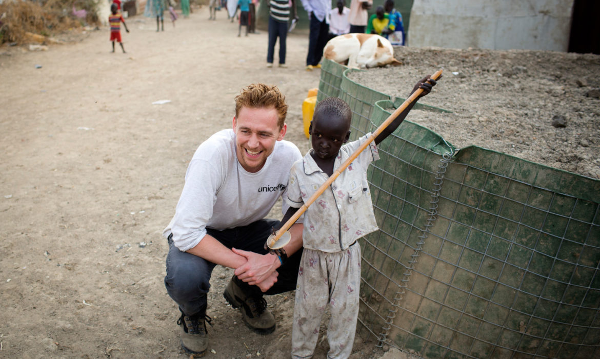 UNICEF UK Ambassador Tom Hiddleston is pictured with a child at the UNMISS protection of civilians camp in Malakal, Upper Nile State, South Sudan