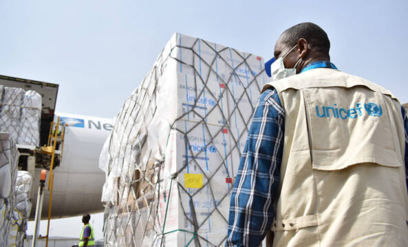 Man carrying supplies including 10,000 test kits, 15 oxygen concentrators, personal protective equipment (PPE), vaccines, emergency health kits and other vital health supplies, which will support the Government’s COVID-19 Response Plan and UNICEF work in support of children and families in Nigeria.