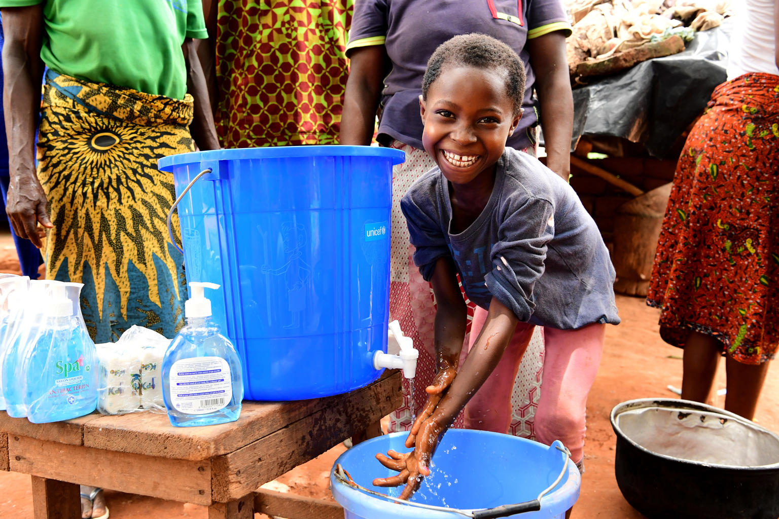 child handwashing smiling
