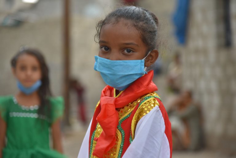 Girl wearing mask looking at camera