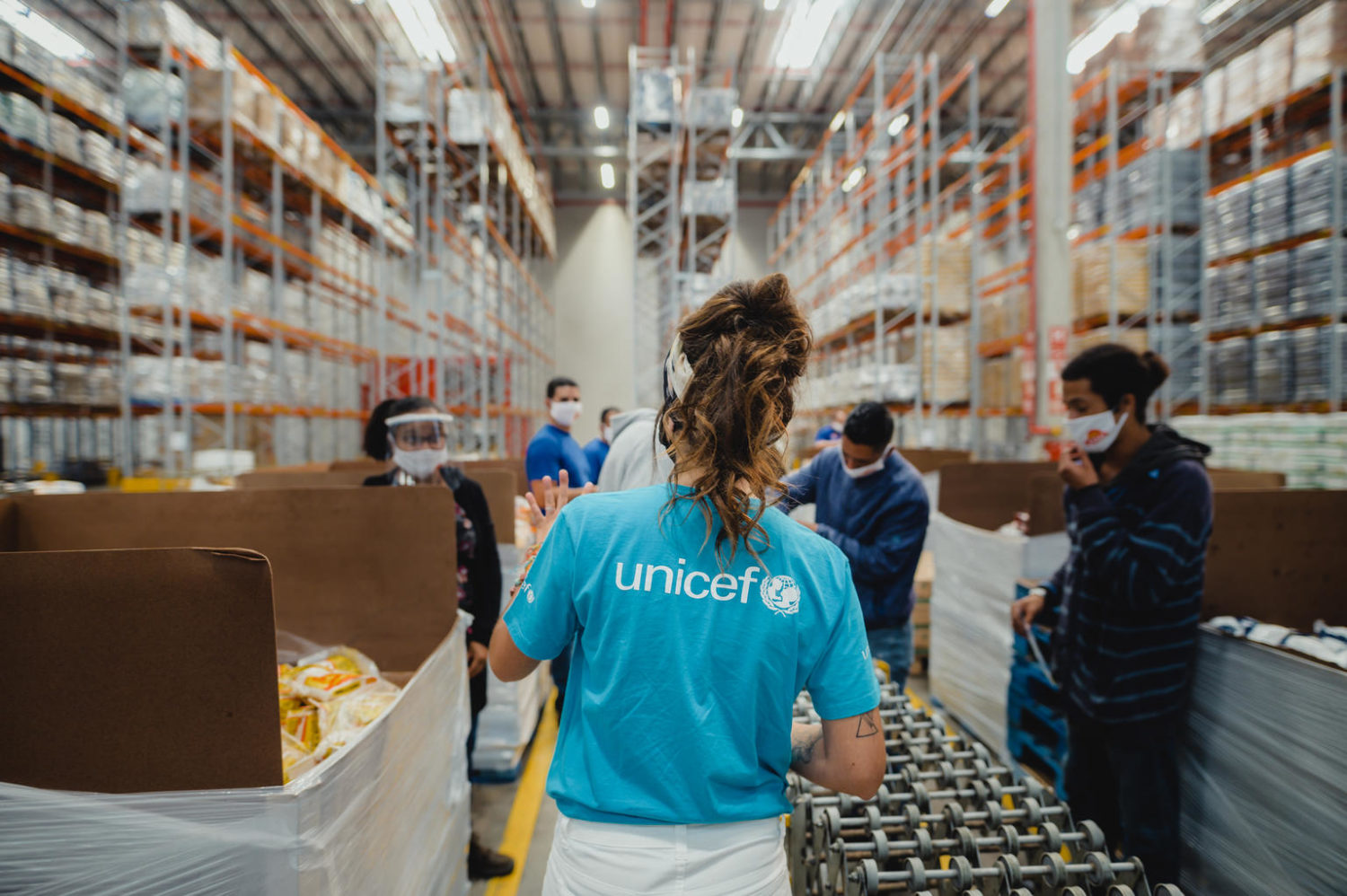 Ludmila Balanin, UNICEF Marketing Services UNV, center, talks to staff members at UNICEF's warehouse in São Paulo, Brazil