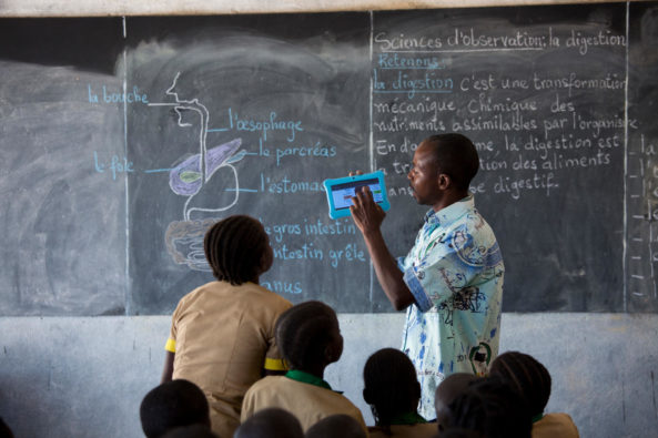 Teacher Albert Matakone teaching children in classroom about the human digestive system