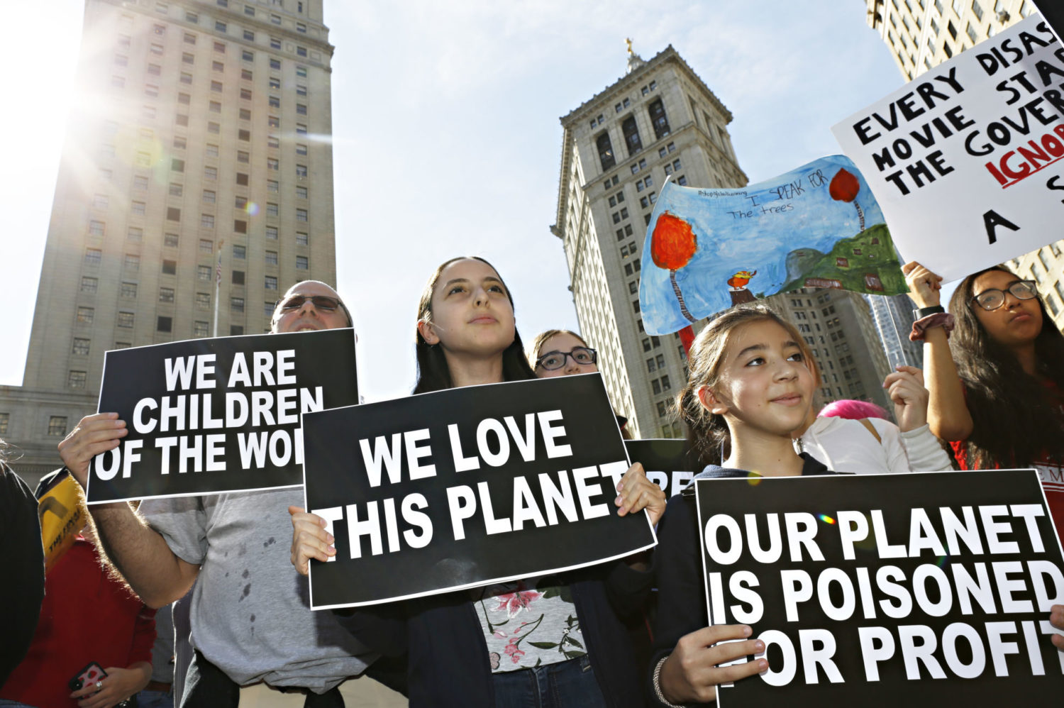 Young girls on a climate change protest holding placcards.