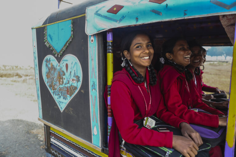 Girls smiling in a car