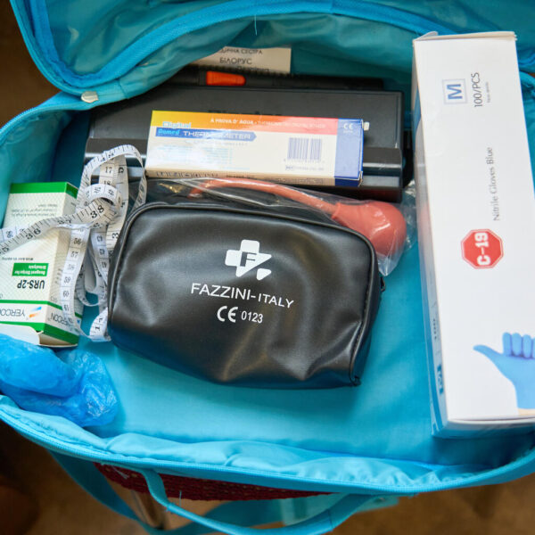 An open first aid kit, revealing medical supplies.