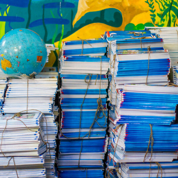 Books stacked in a classroom.