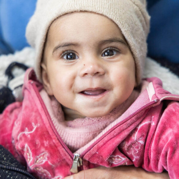 Ten-month-old Kateryna is held by her mother during a visit to Outpatient Clinic No. 10 in Ukraine.