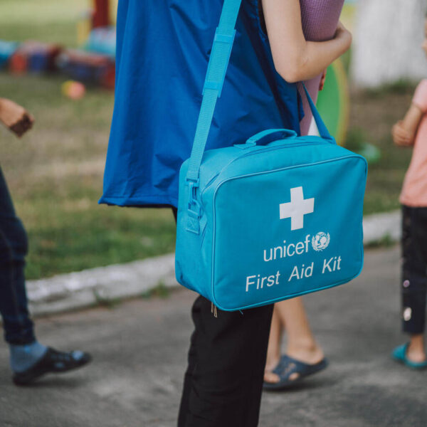Worker of UNICEF mobile team with the first-aid kit who came to visit the displaced people living in a local kindergarten in Ukraine.