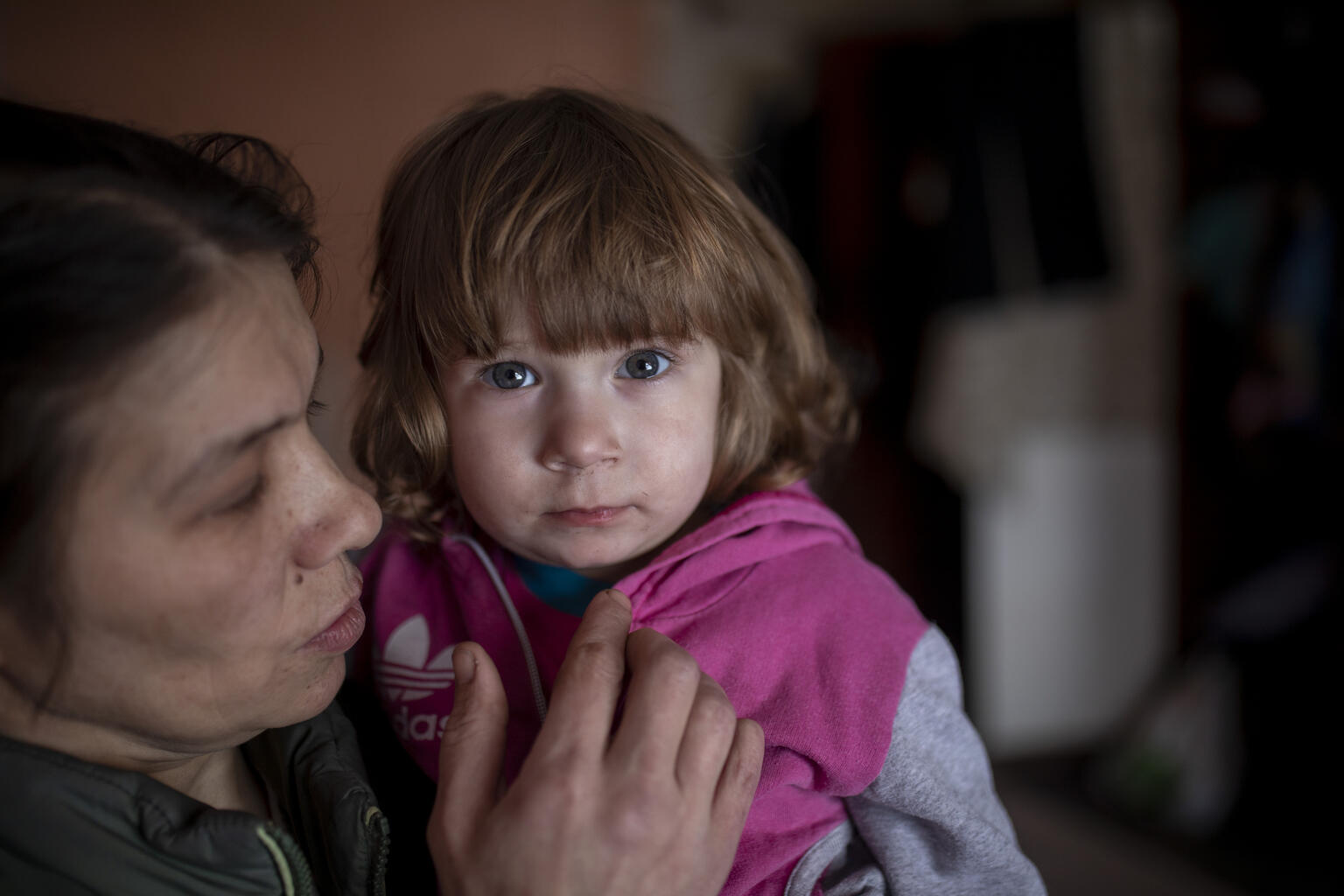 A child is held by their mother in eastern Ukraine.