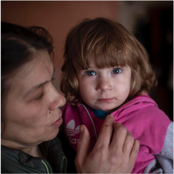 A child is held by their mother in eastern Ukraine.