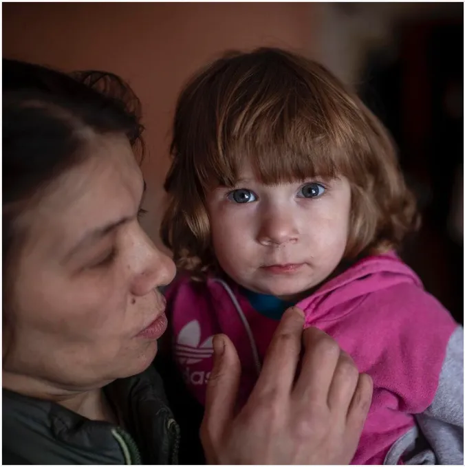 A child is held by their mother in eastern Ukraine.